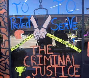Window painting with name "Criminal Justice Club" printed